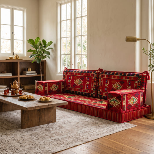 Red Turkish kilim Arabic Majlis floor sofa in a warm living room with traditional patterned cushions and low seating.